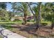 Pleasant view of a well-kept single-story home with a nice lawn and lush landscaping at 13747 Forest Ridge Ct, Hudson, FL 34667