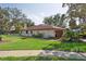Charming home exterior with well-maintained landscaping, a fenced yard, and a spacious garage, exuding curb appeal at 13747 Forest Ridge Ct, Hudson, FL 34667