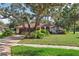 Charming single story home with brick driveway, mature trees, and well manicured landscaping at 13747 Forest Ridge Ct, Hudson, FL 34667
