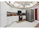Bright kitchen features white cabinetry, black appliances, and tile floors at 13747 Forest Ridge Ct, Hudson, FL 34667