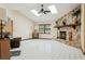 Living room with tile floors, vaulted ceilings, stone fireplace, and large window at 13747 Forest Ridge Ct, Hudson, FL 34667
