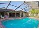 Backyard pool with a screened enclosure, brick pavers, and views of the home's patio area at 13747 Forest Ridge Ct, Hudson, FL 34667