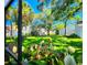 View of the green backyard and the foliage that surrounds the property at 14113 Cypress Cir, Tampa, FL 33618