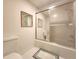 Bright bathroom with tile floor and shower-tub combo with glass doors at 14113 Cypress Cir, Tampa, FL 33618
