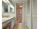 Bathroom featuring a vanity with mirrors and a connecting toilet room with storage at 14113 Cypress Cir, Tampa, FL 33618