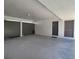 Carport features a gray concrete floor, security gate, and a side door to enter the home at 14113 Cypress Cir, Tampa, FL 33618