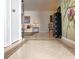 View of the foyer leading into a living room with neutral decor and tiled floors at 14113 Cypress Cir, Tampa, FL 33618