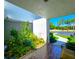 View of front porch featuring brick flooring and lush landscaping at 14113 Cypress Cir, Tampa, FL 33618