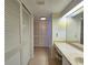 Hallway with double closet doors leading to vanity area with large mirror at 14113 Cypress Cir, Tampa, FL 33618