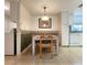 Bright eat-in kitchen featuring neutral tile floors, table with seating, and white cabinetry at 14113 Cypress Cir, Tampa, FL 33618