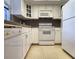Kitchen with white cabinetry, tile floors, and modern appliances at 14113 Cypress Cir, Tampa, FL 33618