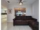 Open-concept living room with comfortable seating area, tile flooring, and view into other rooms at 14113 Cypress Cir, Tampa, FL 33618