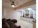 Comfortable sitting area featuring a plush couch, custom built-in shelving, and a light-filled skylight at 14113 Cypress Cir, Tampa, FL 33618