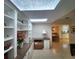Bright study featuring custom built-in shelving, a desk, and a skylight for natural light at 14113 Cypress Cir, Tampa, FL 33618