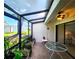 Relaxing sunroom with tiled floor, a ceiling fan, and an array of potted plants at 14113 Cypress Cir, Tampa, FL 33618