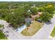 Aerial view of property with mature trees and a dark roof at 1608 Carlos Ave, Clearwater, FL 33755