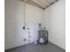 Utility room with gray water heater and concrete flooring at 1608 Carlos Ave, Clearwater, FL 33755