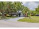 Landscaped front exterior with a palm tree and concrete driveway at 1608 Carlos Ave, Clearwater, FL 33755