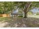Spacious front yard with large trees adding natural charm to this single-story home at 1608 Carlos Ave, Clearwater, FL 33755