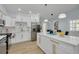 Modern kitchen with white cabinets, stainless steel appliances and central island at 1608 Carlos Ave, Clearwater, FL 33755