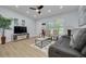 Cozy living room with neutral walls, a decorative ceiling fan, and a comfortable seating arrangement at 1608 Carlos Ave, Clearwater, FL 33755