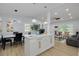 Open-concept living and dining area featuring a kitchen island, modern lighting, and wood-look flooring at 1608 Carlos Ave, Clearwater, FL 33755