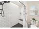 Modern bathroom featuring white subway tiles, a built-in bench, and a stylish shower curtain at 1763 Pebble Hill Ct, Palm Harbor, FL 34683