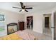 This bedroom features a ceiling fan, carpet, and includes a dresser and closet for storage at 1763 Pebble Hill Ct, Palm Harbor, FL 34683