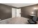 This bedroom has neutral brown colored walls, carpeted floors, and a double door closet at 1763 Pebble Hill Ct, Palm Harbor, FL 34683