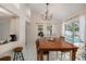 Bright dining room with pendant lighting, tile floors, table with seating for six, and backyard views at 1763 Pebble Hill Ct, Palm Harbor, FL 34683