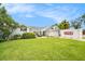 Inviting single-story home with lush lawn, landscape, neutral paint, and ample space for outdoor entertaining at 1763 Pebble Hill Ct, Palm Harbor, FL 34683