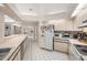 Functional kitchen with white appliances, tiled floors, ample counter space, and an open layout at 1763 Pebble Hill Ct, Palm Harbor, FL 34683