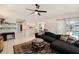 Cozy living room with large sectional sofa, tiled flooring, bright lighting, and modern decor at 1763 Pebble Hill Ct, Palm Harbor, FL 34683