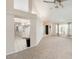 Neutral living room with plush carpeting, bright light, airy open floor plan, and ceiling fan at 1763 Pebble Hill Ct, Palm Harbor, FL 34683