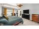 This main bedroom has a ceiling fan and a sliding glass door with access to the outdoor pool area at 1763 Pebble Hill Ct, Palm Harbor, FL 34683