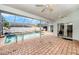 Relaxing screened-in pool area with brick pavers and comfortable lounge chairs at 1763 Pebble Hill Ct, Palm Harbor, FL 34683