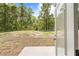 A view from the patio looking out over the backyard to the surrounding trees at 19267 Wildwood Dr, Brooksville, FL 34601