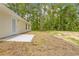 The backyard features a newly installed patio and lush trees at 19267 Wildwood Dr, Brooksville, FL 34601