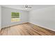 Bedroom featuring hard surface floors, bright light, and neutral paint at 19267 Wildwood Dr, Brooksville, FL 34601