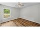 Bedroom with hard surface floors and view of outside from window at 19267 Wildwood Dr, Brooksville, FL 34601