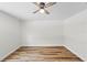 A bright, empty bedroom with wood-look flooring and a ceiling fan at 19267 Wildwood Dr, Brooksville, FL 34601