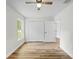 Bedroom with hard surface floors, window and closet at 19267 Wildwood Dr, Brooksville, FL 34601