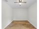 Cozy bedroom featuring hard surface floors, bright light, and a modern ceiling fan at 19267 Wildwood Dr, Brooksville, FL 34601