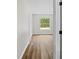 Bedroom with hardwood floors, white walls, closet and a window at 19267 Wildwood Dr, Brooksville, FL 34601
