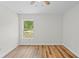 Bedroom with hard surface floors and view of outside from window at 19267 Wildwood Dr, Brooksville, FL 34601