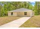 Inviting single-story home with a well-kept lawn and modern neutral-toned siding at 19267 Wildwood Dr, Brooksville, FL 34601