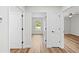 Hallway with doors and wood look flooring leading to different rooms at 19267 Wildwood Dr, Brooksville, FL 34601