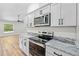 The kitchen has stainless steel appliances and modern countertops with hardwood floors at 19267 Wildwood Dr, Brooksville, FL 34601