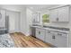 Modern kitchen features gray cabinets, stainless steel appliances, and beautiful granite countertops at 19267 Wildwood Dr, Brooksville, FL 34601