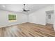 Living room showcasing hard surface floors, neutral paint, bright light, and an entry door at 19267 Wildwood Dr, Brooksville, FL 34601